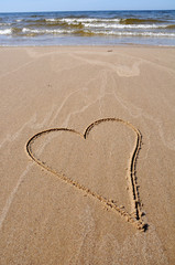 heart drawing on beach sand