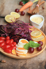 fresh red spinach salad and cream on wooden table