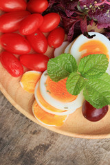 fresh red spinach salad and cream on wooden table
