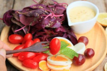 fresh red spinach salad and cream on wooden table