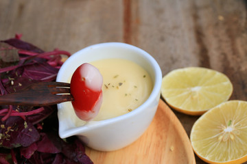 fresh red spinach salad and cream on wooden table