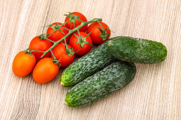 Cucumbers and tomatoes on the branch