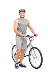 Naklejka premium Young man posing next to his bicycle and smiling