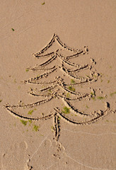 Christmas tree drawing on beach sand