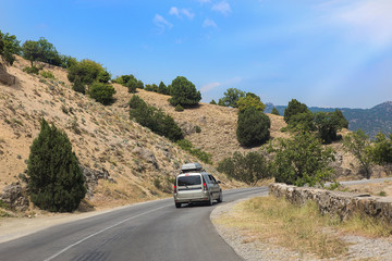 Obraz na płótnie Canvas cars moving along mountain road in Crimea