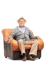 Relaxed senior gentleman sitting in an armchair
