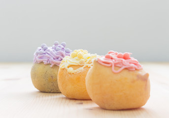 3 Color Choux or Profiterole or Eclair on Wood Table Oblique Vie
