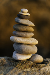 Stack of balanced pebbles, stones against colorful rock