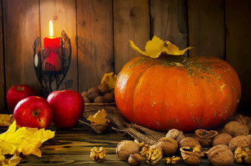 Naklejka na ściany i meble Thanksgiving - pumpkin, nuts, apples with candlelight