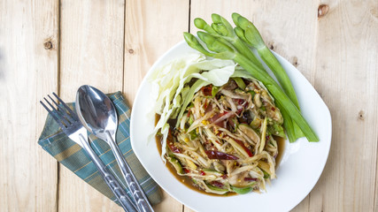 papaya salad on wood background