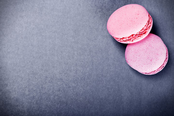 colourful french macaroons on a black background