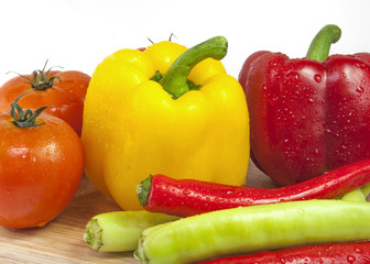 Mixed collection of fresh organic vegetables isolated on a white background. Healthy vegetarian food with wooden bowl of salad.