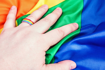 Fototapeta premium Ring rainbow gay on his finger