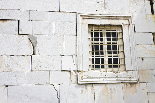 Stone wall deeply cracked with window - concept image background