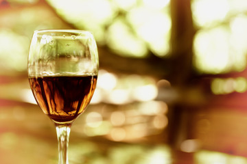 A glass with cognac glare in sunlight