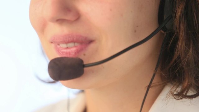 Extreme close up of mouth of young woman with microphone and headset