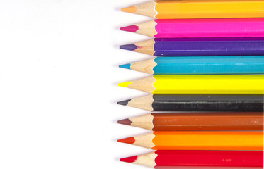 Line of colored pencils isolated on white background close up