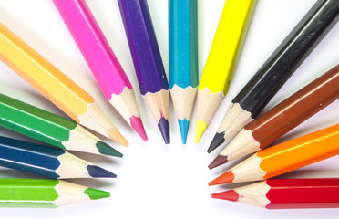 Line of colored pencils isolated on white background close up