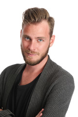 Obraz premium A handsome man standing with a white background wears a grey sweater and a black t-shirt. Feeling good with a smile on his face. 