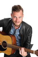Adult singer-songwriter sitting down with an acoustic guitar. White background.