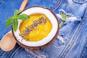 Breakfast mango and berry smoothies garnished with chia seeds,  bee pollen in coconut