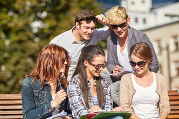 group of happy students with notebooks at campus