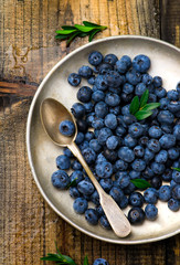fresh blueberry in to the vintage metal plate