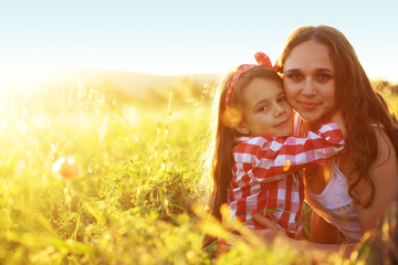 Mother with her child in spring field