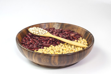 Red bean and soybean in wooden plate on on white background. Condiment for vegetarian food.