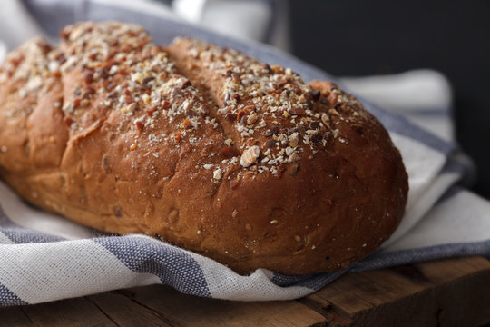 Dark multigrain bread whole grain fresh baked on rustic