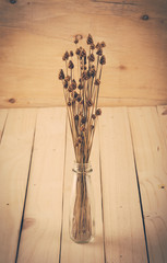 dry grass flower on wood background