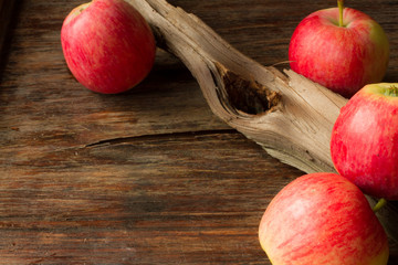 ripe red apples on a wooden background