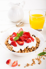 Yogurt with granola and fresh strawberries