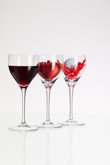 Wine glasses with red wine, heart and golf ball