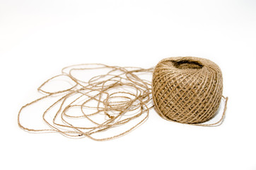 Obraz premium Skein of hard brown twine on a white background