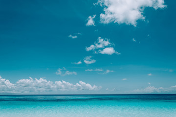 blue sky with sea and beach - soft focus with film filter