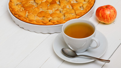 Cup of green tea and homemade pie with apples and pears