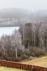 Countryside view frosty hilly fields with trees
