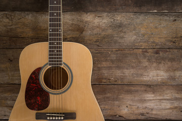Obraz premium Top view of guitar on dark wood floor texture in darken tone