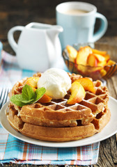 Belgian waffles with ice cream and fresh peaches