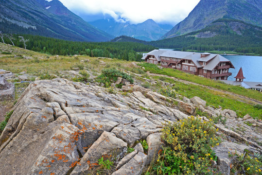 Hotel nestled below cliff in Glacier National Park.