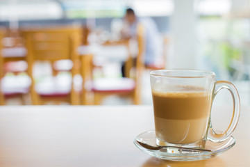 hot latte coffee on wooden table, vintage and retro style