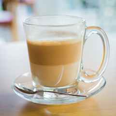 hot latte coffee on wooden table, vintage and retro style