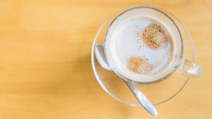 hot latte coffee on wooden table, vintage and retro style