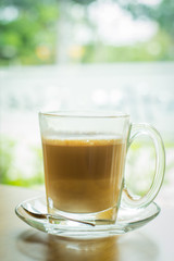 hot latte coffee on wooden table, vintage and retro style