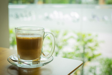 hot latte coffee on wooden table, vintage and retro style