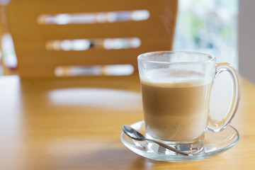 hot latte coffee on wooden table, vintage and retro style