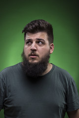 Fototapeta premium Confused man portrait, looking to right side. Green screen backg
