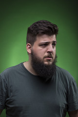 Obraz premium Confused man portrait, looking to right side. Green screen backg