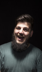 Fototapeta premium Hilarious smiling man portrait, on black background.